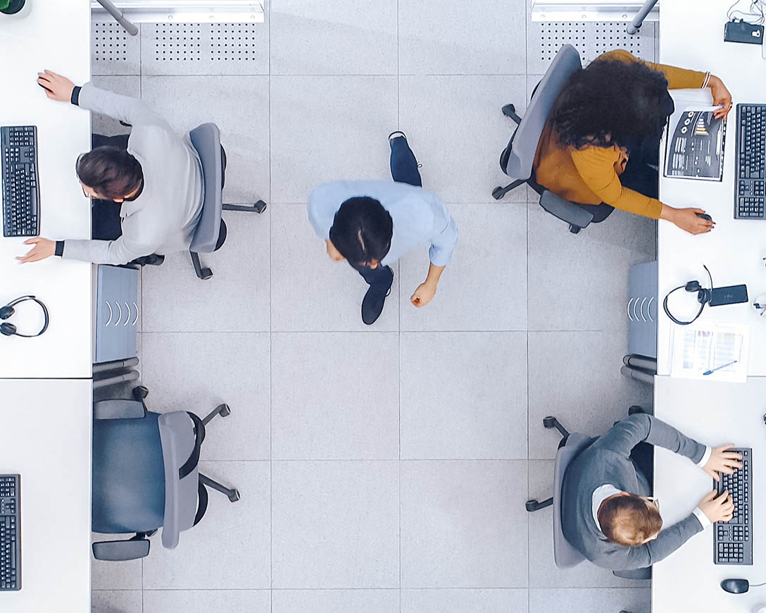Resilience – Overhead view of people working in a clean, open space office