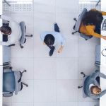 Resilience – Overhead view of people working in a clean, open space office