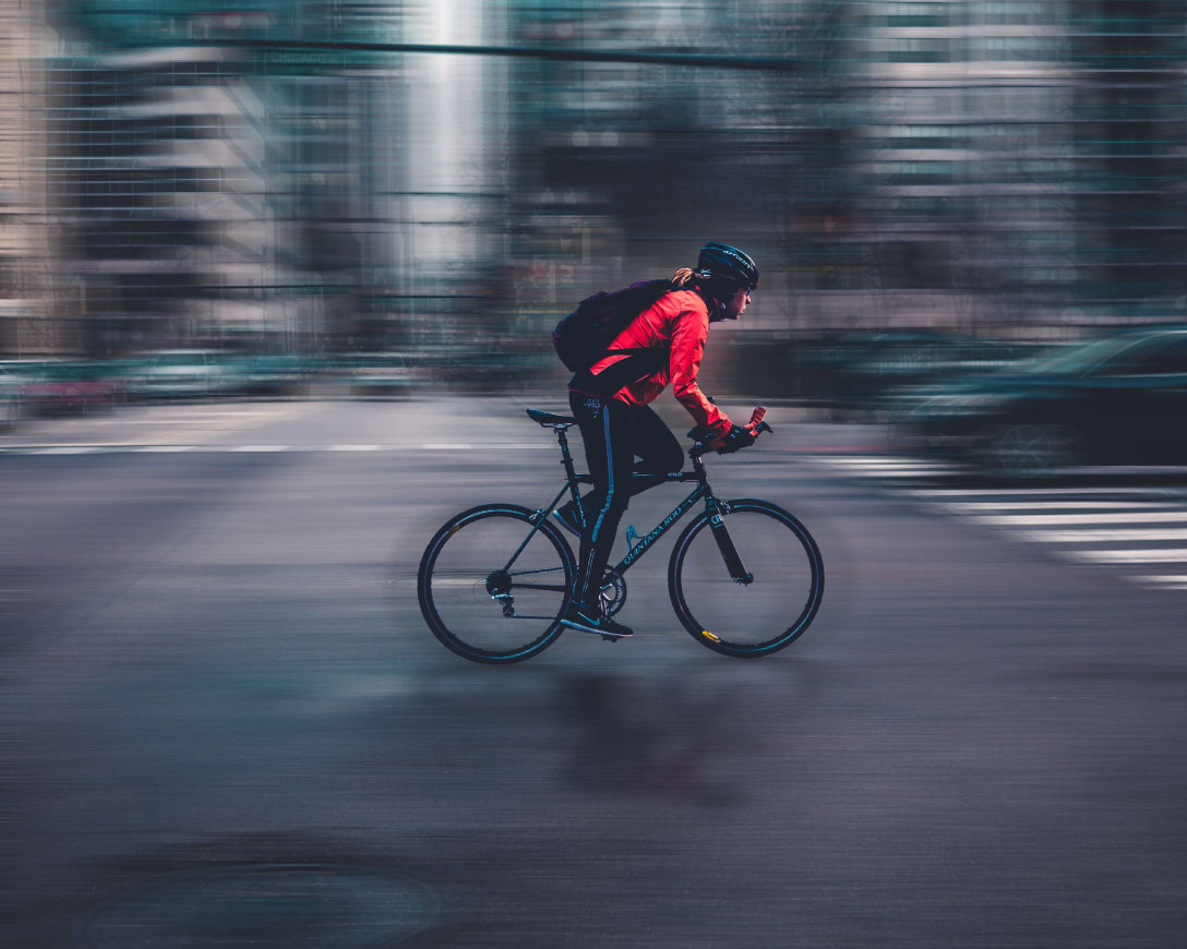 Man cycling on busy city street.