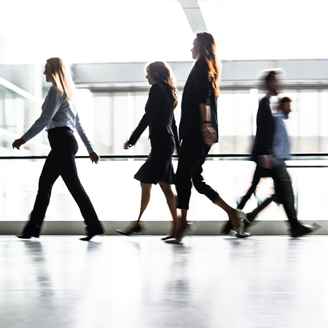 Business people walking through the lobby.