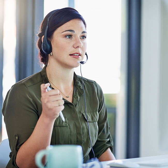 Shot of a young call centre agent working in an office