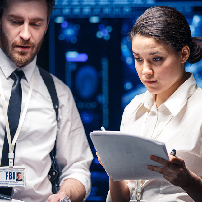 A man and woman examining a document with focused attention