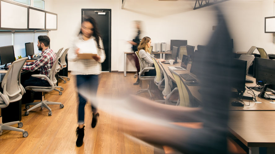 Office workers in action, blurred image.