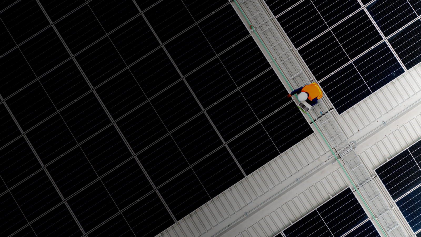 A man diligently working on a solar panel, harnessing renewable energy to power the world sustainably.